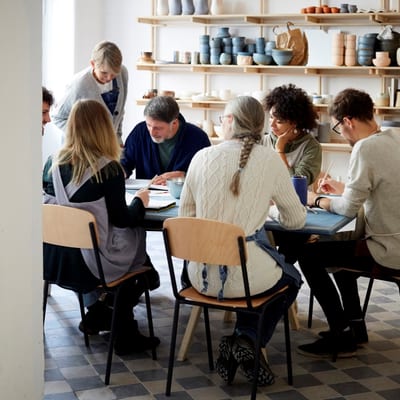 Group meeting around table pottery studio